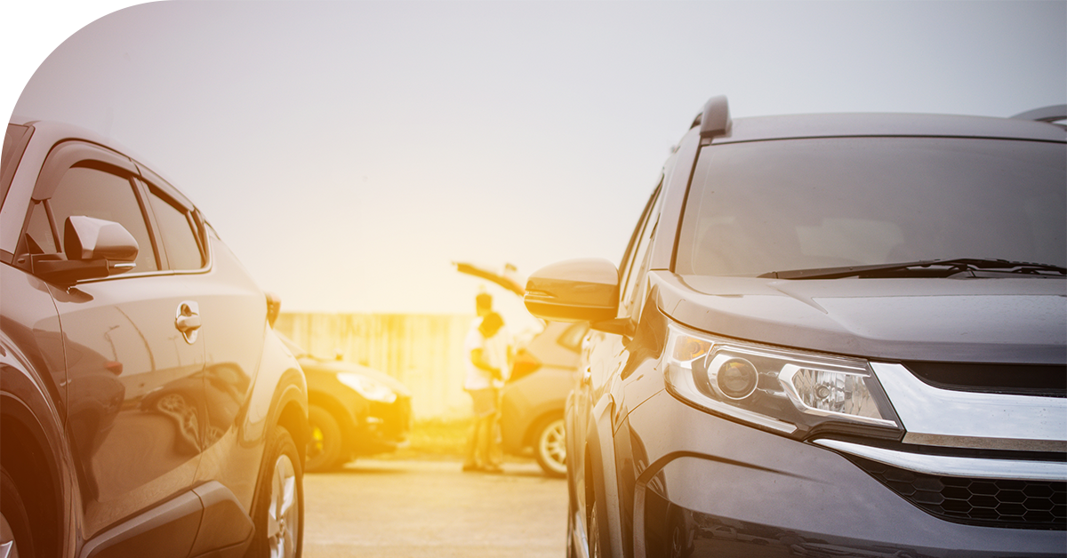 cars in a dealership header image sunlight